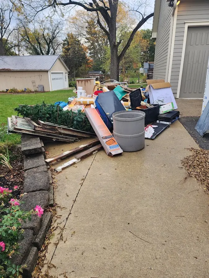 Dumpster being loaded with debris for Estate Cleanout Dumpster Rental in Burke Centre